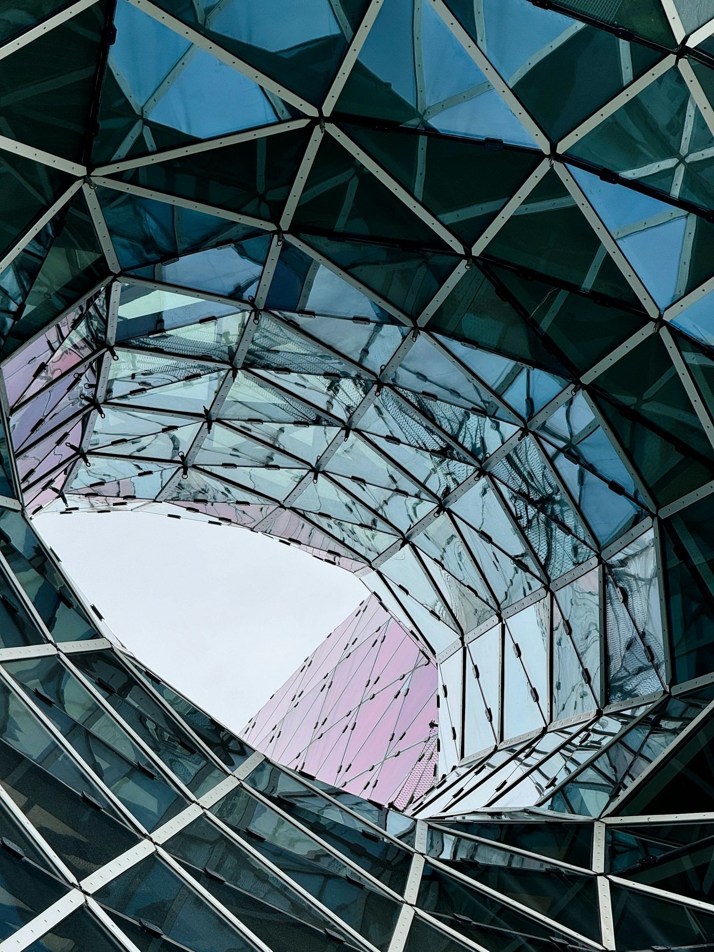 Geometric glass roof with an opening above.